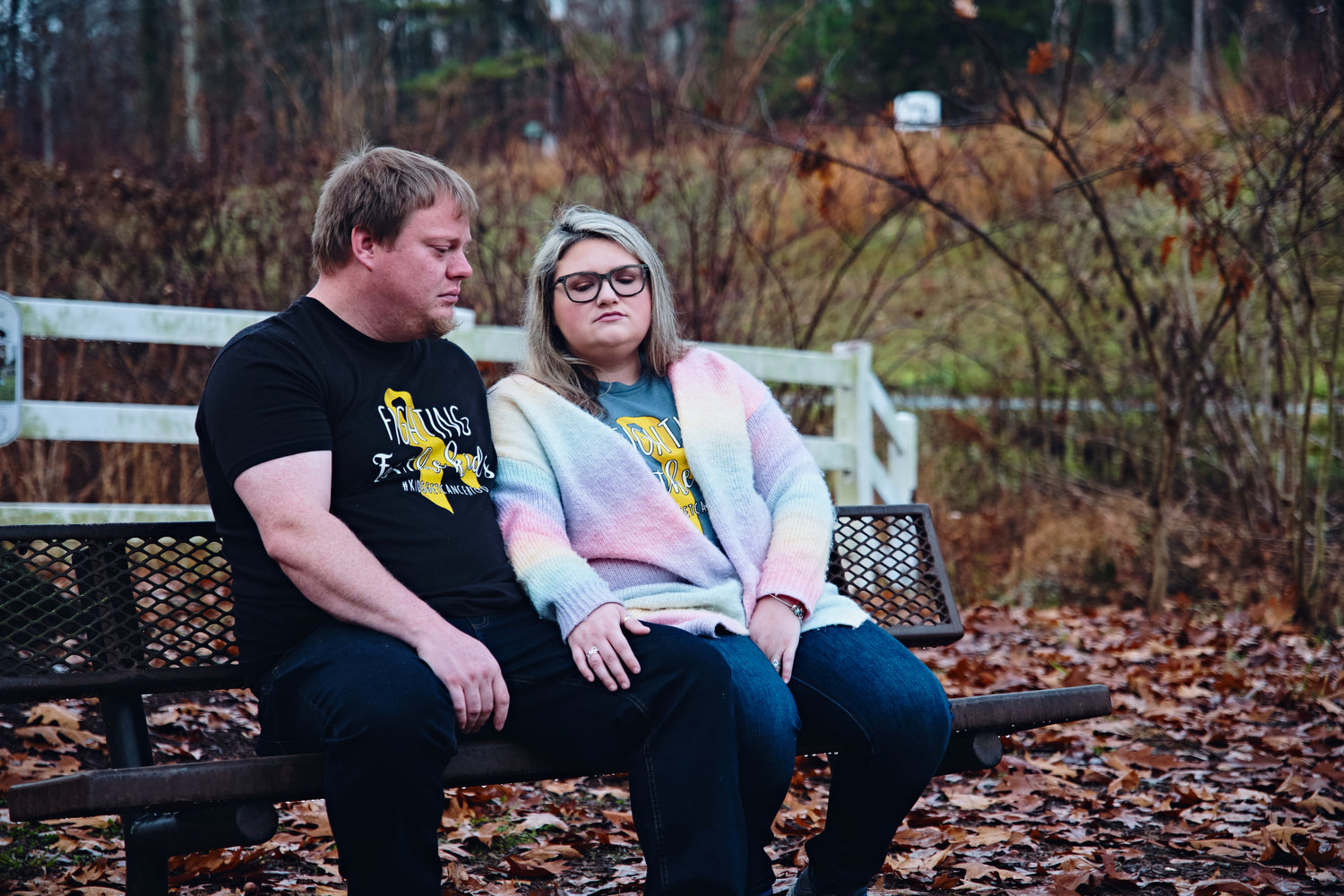 Dusty and Meghan Scoggins sit at a bench in Boling Lane Park in Siler City, where they would often bring their 5-year-old daughter Kenzie before her passing in September. Kenzie was diagnosed with diffuse intrinsic pontine glioma (DIPG) almost a year ago today.
